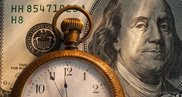 Image of a pocket watch and a 20 dollar bill